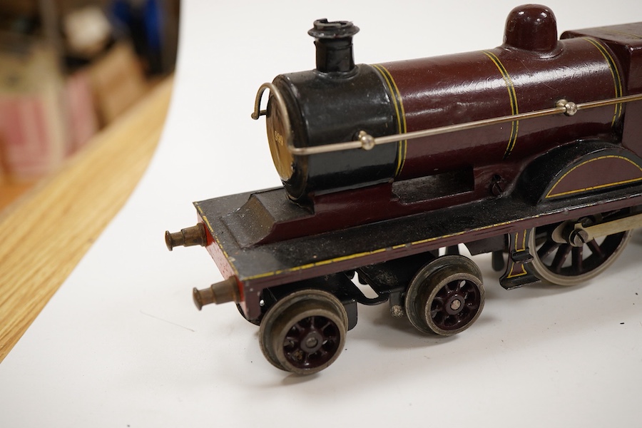 An 0 gauge Bing clockwork tinplate Midland Railway 4-4-0 tender locomotive, 999, in maroon livery with yellow and black lining and original clockwork mechanism
